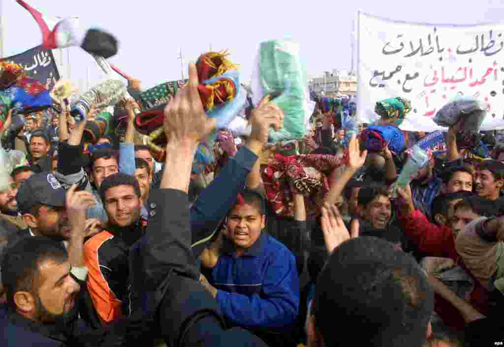 Iraqi supporters of radical Shi'ite cleric Muqtada al-Sadr.demonstrate Friday, 16 December 2005, in Sadr City near Baghdad. They called for the immediate release of Shi'ite cleric Ahmed al-Shibani, an aide to Sadr