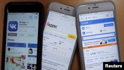 Ukraine -- Mobile phones display home pages of Mail.ru, Vkontakte social network, and Yandex - generic