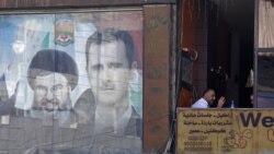 Dəməşqdə Bashar al-Assad və Hizbullah lideri Hassan Nasrallahın birgə portreti olan plakat