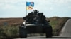 UKRAINE – A Ukrainian tank rides with a flag picturing Ukraine and US flags shaking hands in Novostepanivka, Kharkiv region, on September 19, 2022